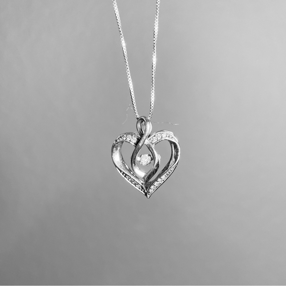 Sterling silver .11 carat diamond heart necklace. Dancing diamond. 16 diamonds